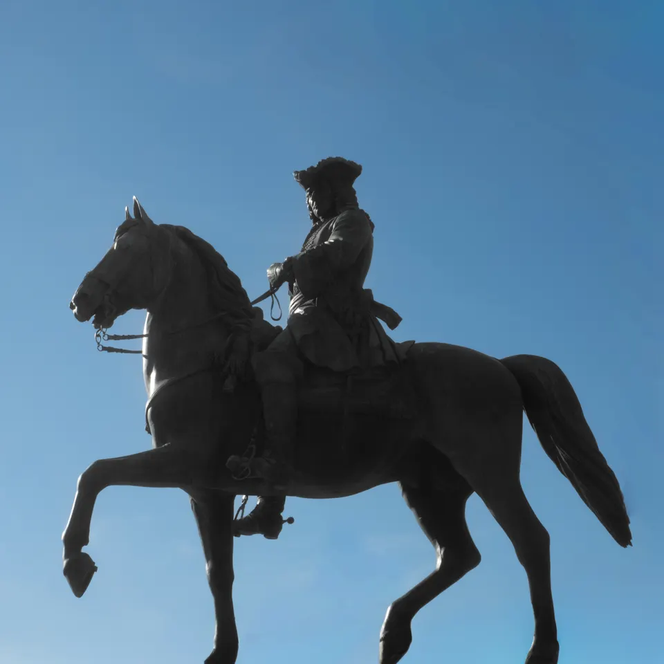 A bronze horse and rider on the Maria Theresa Monument in Vienna