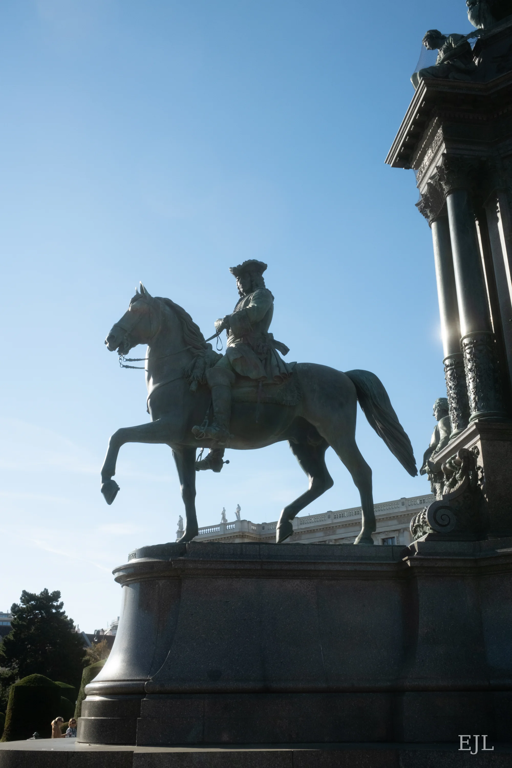 A bronze horse and rider on the Maria Theresa Monument in Vienna