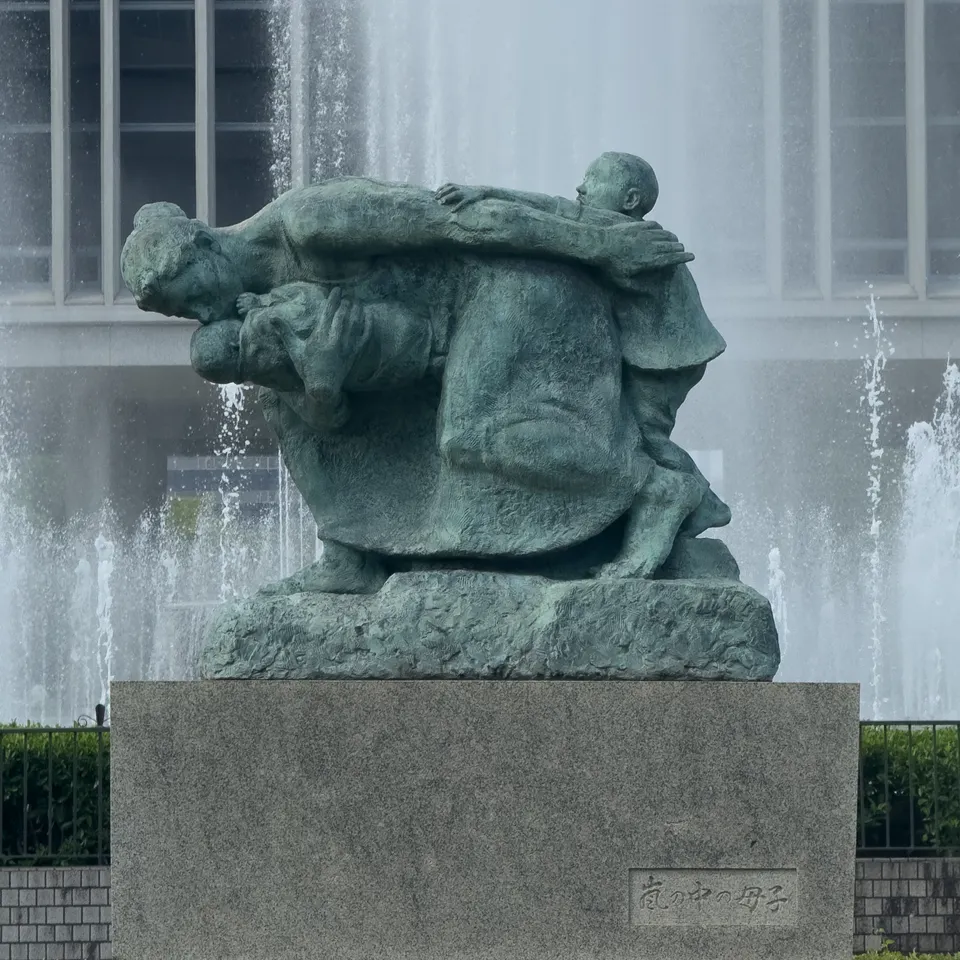 The Mother and Child in the Storm sculpture in front of fountains in Hiroshima